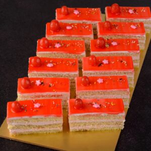 New Strawberry Cake pieces 80 gms. Moist, pink strawberry cake slice, 80 grams, with visible strawberry bits.