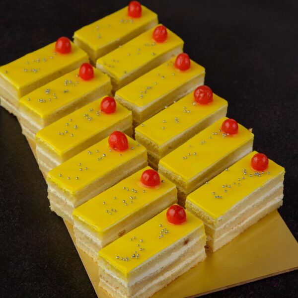 Pineapple cake 80 gms. Moist pineapple cake slice with visible fruit pieces, 80 grams.