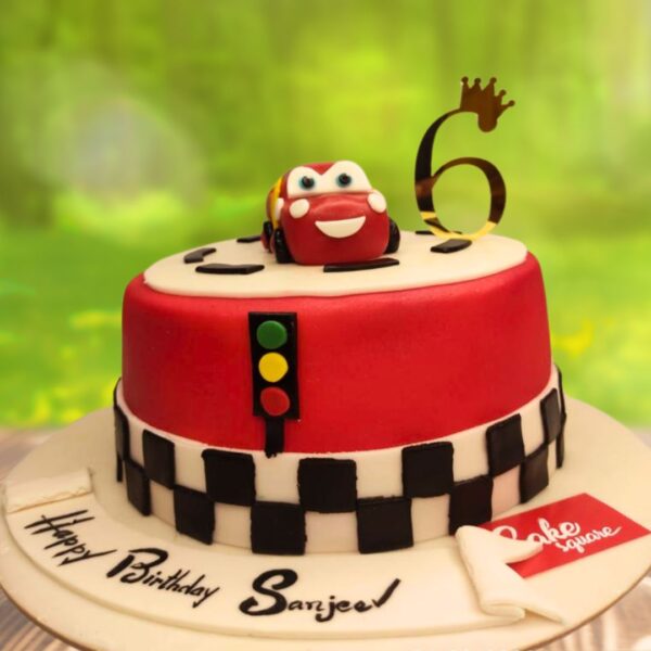 Amazing McQueen Car Birthday Cake 2 Kg. Vibrant 2kg Lightning McQueen shaped birthday cake with realistic car details