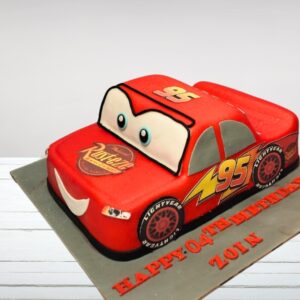 Amazing McQueen Car Birthday Cake 3 Kg. Dynamic 3kg Lightning McQueen-shaped birthday cake with vivid racing details