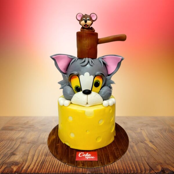 Amazing Tom and Jerry theme 2-tier kids First birthday cake. Playful 2-tier Tom and Jerry themed first birthday cake with cartoon character decorations