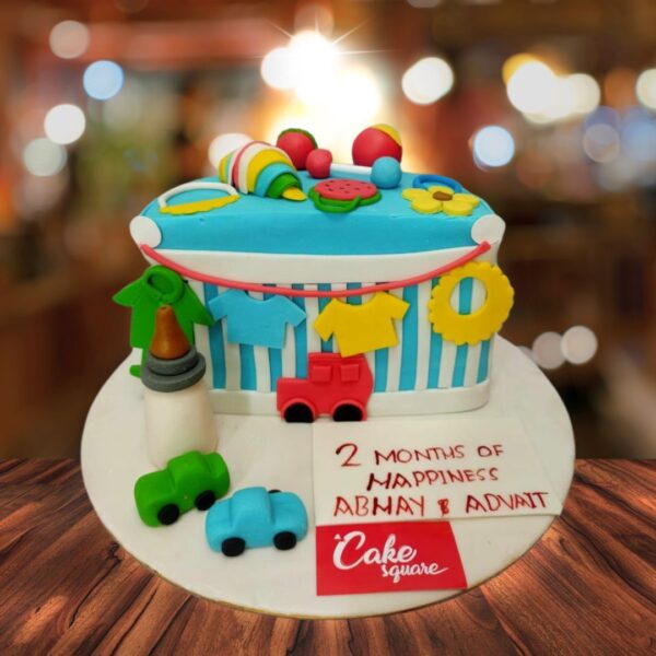 "Beautiful Half Birthday Cake 1 Kg with cute baby toy decorations, perfect for a playful and memorable half-birthday celebration."