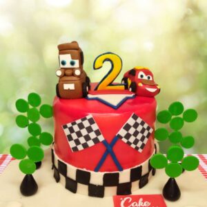 "McQueen Car Second Birthday Cake 1 Kg with dynamic McQueen car decorations, ideal for a thrilling and fun second birthday celebration."