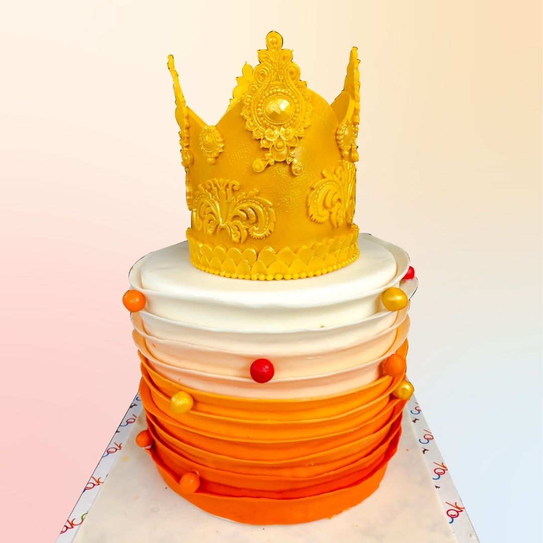 A Peach Royal Crown Theme Birthday Cake 2 kg, elegantly decorated with a golden crown and peach-colored accents, perfect for a regal celebration.