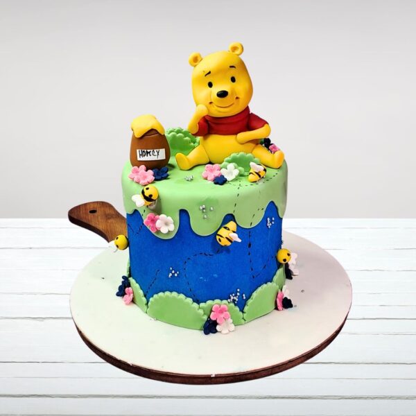 "Winnie the Pooh 1 Kg Customised Birthday Cake featuring beloved Winnie the Pooh characters, perfect for a charming and personalized birthday celebration."