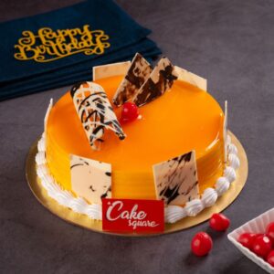 A mango filled cake on a vanilla sponge is made perfectly and decorated with square chocolate ganches in this Fresh Mango 500 gms Birthday Cake by Cake Square Team