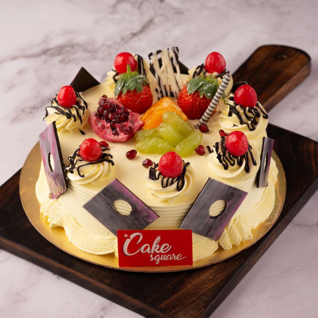 A cake thats filled with caramelised butter scotch cashew nuts is also loaded with all fresh fruits on top along with red cherries in full circle. This is Full Of Fruit Butter scotch 1 kg anniversary Cake is made by Cake Square Team.