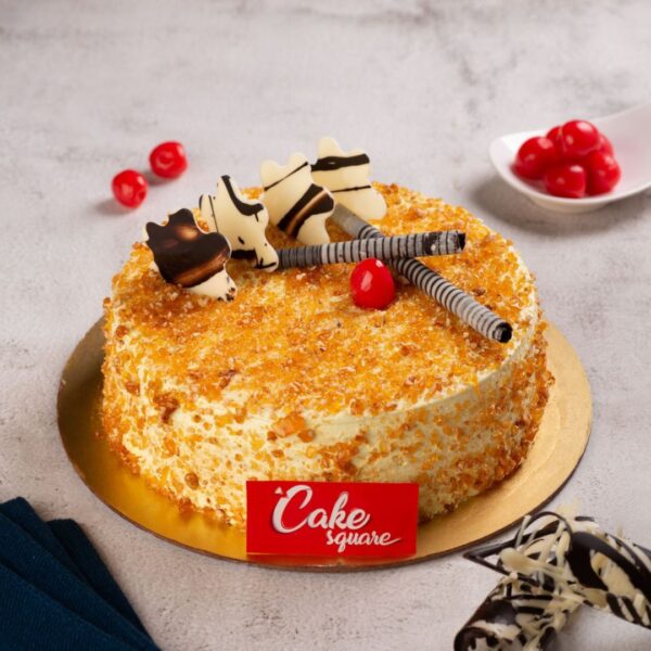A vanilla sponge filled with butterscotch nuts and also topped fully on the surface with nuts and to give a spot light , couple of cherries and chocolate sticks is our Full Of Nuts ButterScotch 1 kg Birthday Cake. Made by Cake Square Team