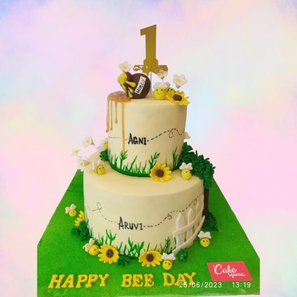 Cute Honey Bee Theme First Birthday Cake 4 kg with a honey bee theme, decorated with bee figures and cream frosting, ideal for a sweet celebration.