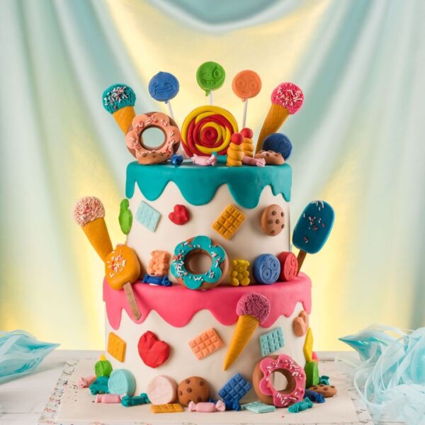 "Donut Theme 2 Tier Kids First Birthday Cake with vibrant colors and donut designs, perfect for a sweet and fun first birthday party."