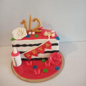 "1 kg colorful half birthday cake for kids with '1/2' topper and playful decorations"