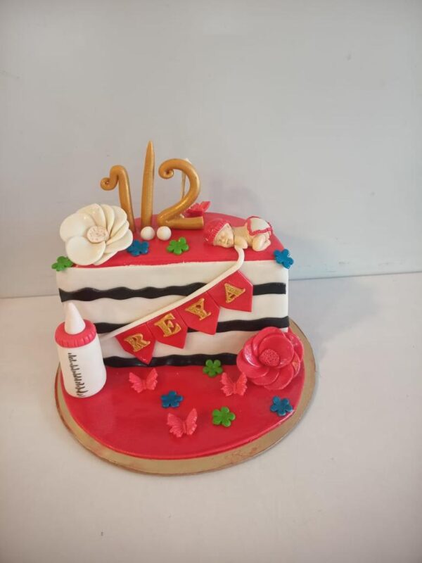 "1 kg colorful half birthday cake for kids with '1/2' topper and playful decorations"