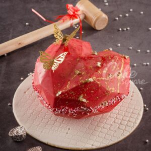 Large red heart-shaped pinata cake bursting with candy surprises