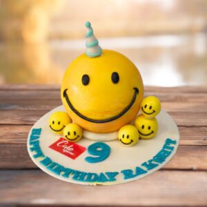 Smiley pinata 1 Kg Birthday Cake featuring a large yellow smiley face design, filled with colorful candies and cheerful treats.