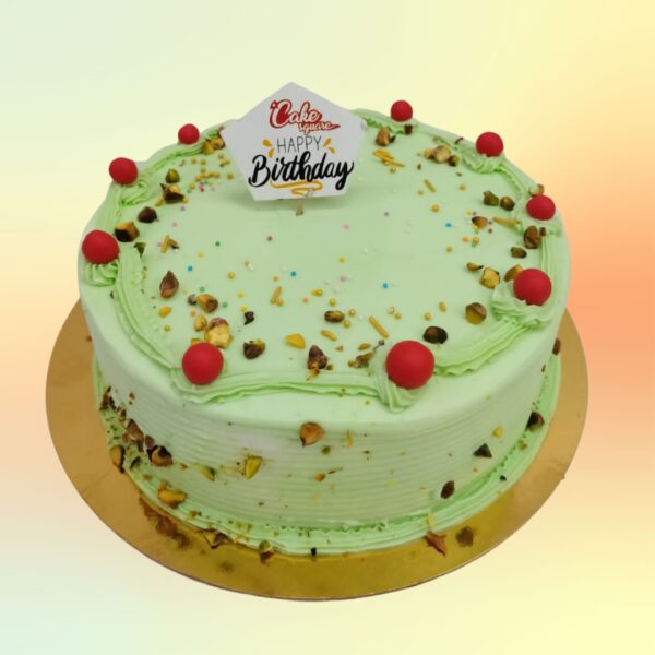 1 kg birthday cake with pistachio flavor and green nut decorations. Made by Cake Square Team.