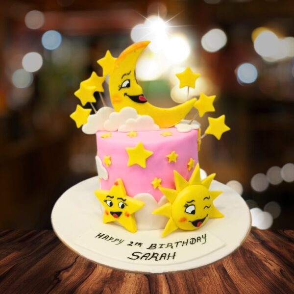 "Sun Moon & Star Pink Kids Birthday Cake 1 Kg with vibrant sun, moon, and star decorations, perfect for a dreamy and colorful birthday celebration."