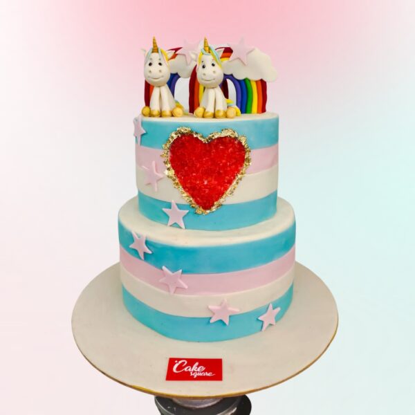 A grand 4 kg cake with two tiers, designed in a whimsical unicorn theme. The bottom tier is larger, covered in a swirling pastel rainbow pattern. The top tier is white with a pearlescent finish. Two fondant unicorn figures, each with a different pastel-colored mane and tail, stand on top. Their horns and hooves are painted gold. Fondant clouds, stars, and flowers in soft pastel hues decorate the sides of both tiers. A spray of edible gold glitter adds sparkle. Two golden "1" numbers nestle between the unicorns, signifying the twins' first birthday.