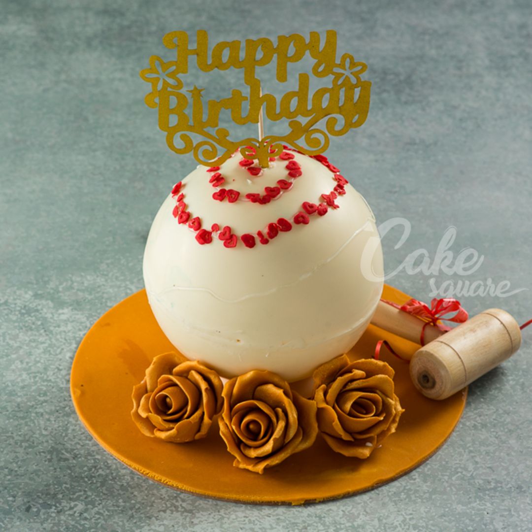 Large white round cake with hidden birthday surprise inside