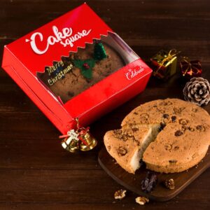 Buy Christmas Dates and Walnut Cake 250 gms elegantly displayed on a festive table, showcasing its moist texture and rich ingredients, perfect for holiday celebrations.