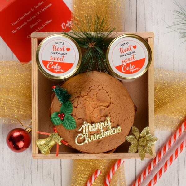 A Cute tea cake Gift Combo @699 displayed with its festive packaging, showcasing the delicious plum cake inside, ready to spread holiday joy.