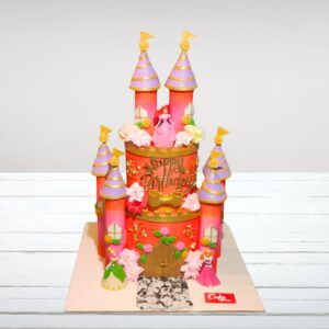 "Elaborate multi-tiered princess castle cake with towers, flags, and first birthday decorations"