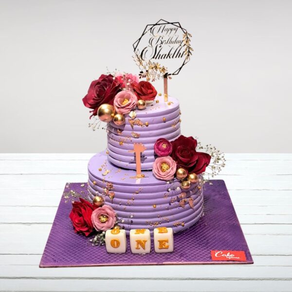 Cake Square's elegant Creamy Two Tier First Birthday Cake 3 Kg with creamy frosting and pastel decorations