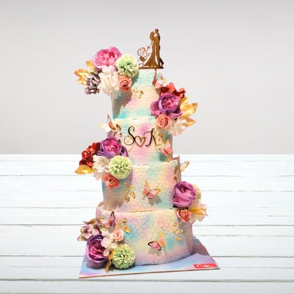 Whimsical, multi-tiered Cute Wedding Cake Design 7 Kg adorned with fondant decorations, including hearts, flowers, and other charming accents.