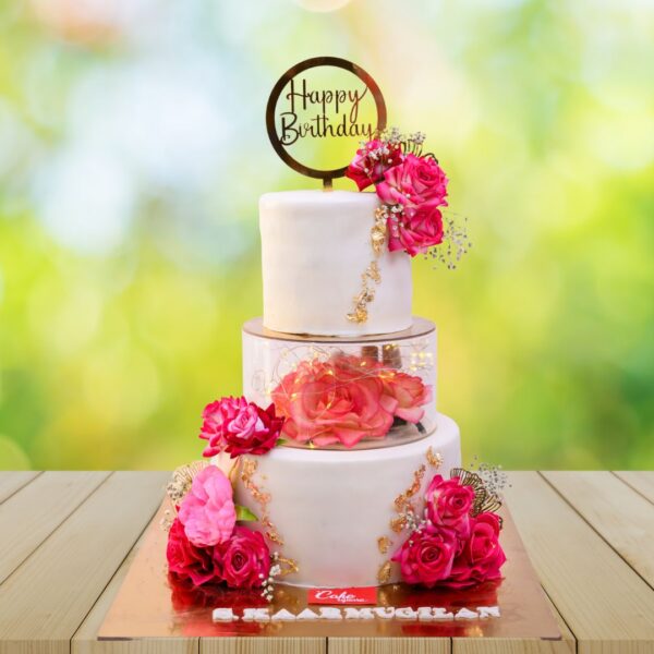 Elegant three-tier engagement cake with white fondant, gold accents, and delicate sugar flowers in this Most Prettiest 3 Layer Engagement Cake