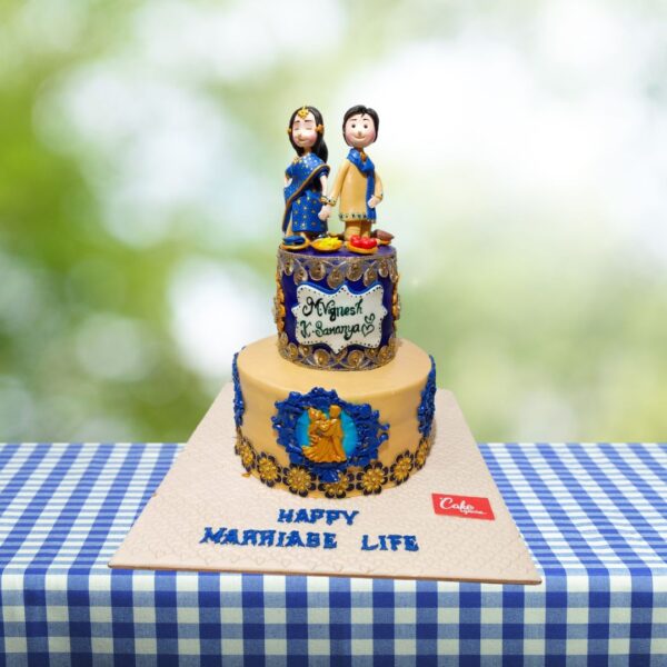 Whimsical wedding cake featuring a fondant topper of a happy, embracing bride and groom showcasing in this Smiling Couple Wedding Cake 4 Kg.