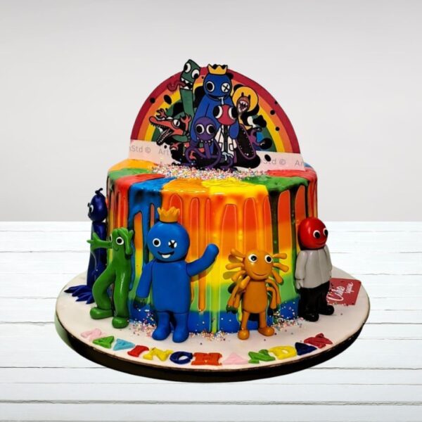 A colourful Wild Monsters Rainbow Kids Theme Cake adorned with playful monster decorations and a bright rainbow design, ideal for children's birthday parties.