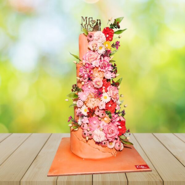 "Peach Floral wedding cake 8 kg featuring delicate peach-colored blooms cascading down tiers, perfect for a romantic spring or summer wedding. Order your wedding cake from Cake Square Chennai."