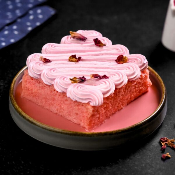 "Elegant Rose Tres Leches Cake 800 gms - A delicate fusion of rose essence and traditional tres leches cake, adorned with fresh rose petals and whipped cream"